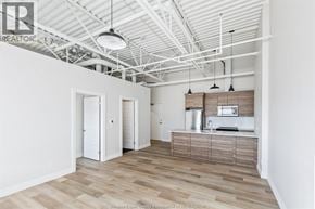 Lasalle apartment for rent - A spacious kitchen with white cabinets and a wooden island.