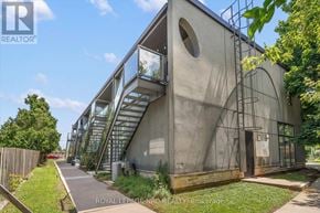 St. Catharines (Lakeport) multi-family for rent - A modern house with a glass staircase and a circular window.