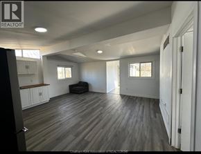Shrewsbury apartment for rent - A spacious room with wooden flooring and white walls.
