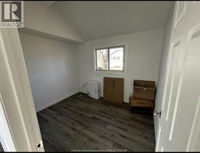 Shrewsbury apartment for rent - A room with a window, a white box, and a brown box on the floor.