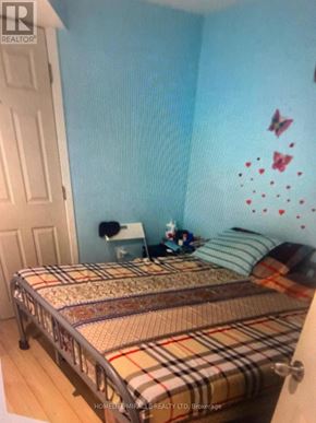 Toronto (Agincourt South-Malvern West) apartment for rent - A bedroom with a bed, a nightstand, and a wall decal.