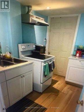 Toronto (Agincourt South-Malvern West) apartment for rent - A kitchen with a stove top oven and a sink.
