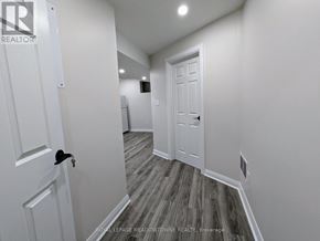 Newmarket (Huron Heights-Leslie Valley) apartment for rent - A hallway with a white door and a wooden floor.