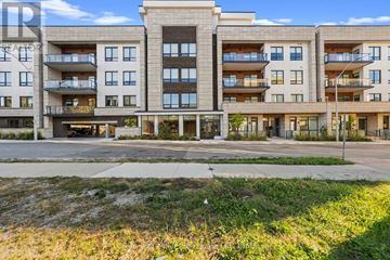 Oakville (Co Central) condo for rent - A large apartment complex with multiple balconies and doors.