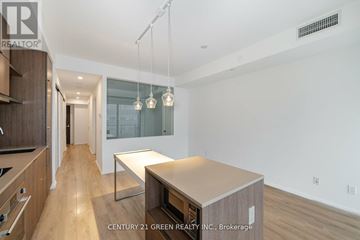 Toronto (Church-Yonge Corridor) condo for rent - A modern kitchen with wooden cabinets and a central island.
