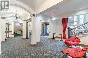 Toronto (Church-Yonge Corridor) condo for rent - A brokerage office with a staircase and a red chair.