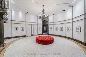 Toronto (Church-Yonge Corridor) condo for rent - A room with a red ottoman in the middle and pictures on the wall.