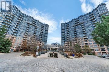 Markham (Unionville) condo for rent - A large building complex with a courtyard in the foreground.