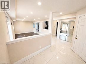 Kitchener apartment for rent - A spacious room with a kitchen area and a tiled floor.