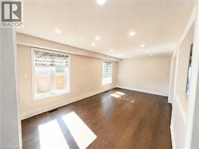 Kitchener apartment for rent - A sunny room with a window and wooden floors.