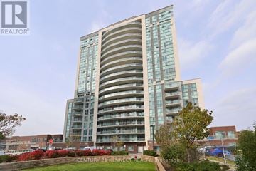 Toronto (Wexford-Maryvale) condo for rent - A tall building with a curved design is surrounded by greenery.