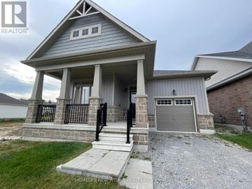 Georgina (Sutton & Jackson's Point) apartment for rent - A house with a grey roof and a porch with a black railing.