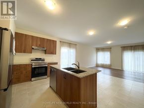 Georgina (Sutton & Jackson's Point) apartment for rent - A kitchen with wooden cabinets and a granite countertop.