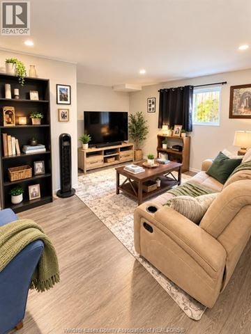 Tecumseh apartment for rent - A living room with a blue couch and a beige sofa.