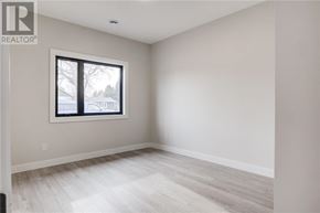 Azilda apartment for rent - A room with a window and a wooden floor.