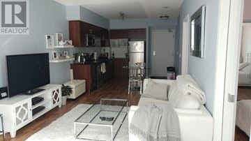 Toronto (Niagara) condo for rent - A living room with a white couch and a TV.
