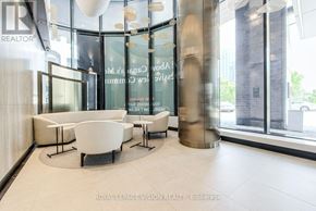 Toronto (Waterfront Communities) condo for rent - A modern waiting area with white furniture and glass walls.