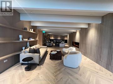 Vaughan (Vaughan Corporate Centre) condo for rent - A modern living room with a large couch and a coffee table.