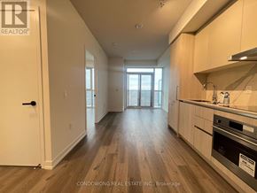 Vaughan (Vaughan Corporate Centre) condo for rent - A kitchen with wooden floors and white walls.