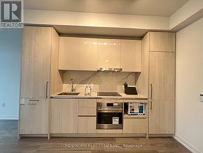 Vaughan (Vaughan Corporate Centre) condo for rent - A kitchen with wooden cabinets and a stainless steel sink.