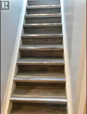 Lethbridge apartment for rent - A set of stairs with wooden steps and metal handrails.