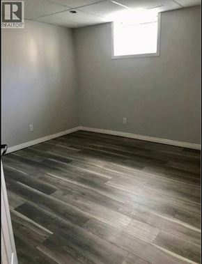 Lethbridge apartment for rent - A room with wooden flooring and a window.