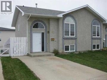 Lethbridge apartment for rent - A house with a white fence in front of it.