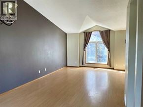 Lethbridge apartment for rent - A room with a large window and wooden flooring.