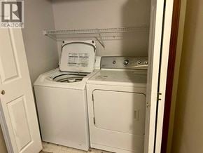 Lethbridge apartment for rent - A white dryer and washer are in a small laundry room.