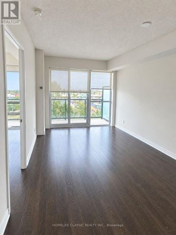 Toronto (Downsview-Roding-Cfb) condo for rent - A room with wooden floors and a sliding glass door leading to a balcony.