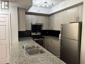 Brampton (Westgate) townhouse for rent - A kitchen with a sink, stove, and refrigerator.