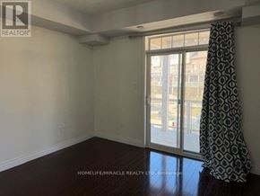 Brampton (Westgate) townhouse for rent - A room with a sliding glass door and a curtain.