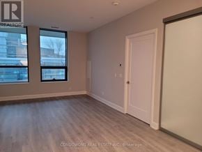 Markham (Commerce Valley) condo for rent - A room with a white door and a window with a view of a building outside.