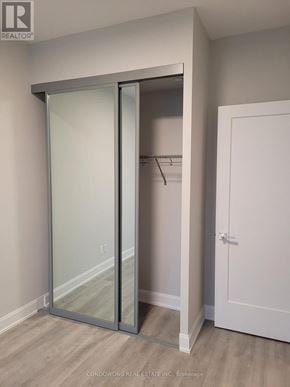 Markham (Commerce Valley) condo for rent - A white closet with a glass door and a white door.
