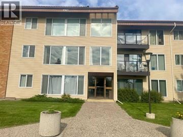Lethbridge apartment for rent - A building with a brown facade and a glass door entrance.