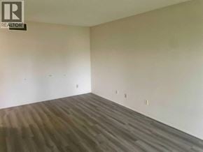 Lethbridge apartment for rent - A room with wooden flooring and white walls.