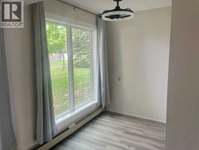 Lethbridge apartment for rent - A room with a window and a ceiling fan.
