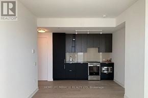 Mississauga (City Centre) condo for rent - A modern kitchen with black cabinets and stainless steel appliances.