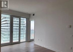 Mississauga (City Centre) condo for rent - A room with a large window and a sliding glass door.
