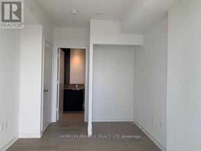 Mississauga (City Centre) condo for rent - A realtor photo of an empty room with a doorway leading to another room.