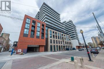 Hamilton (Beasley) condo for rent - A building with a red brick facade is in the foreground with a modern building in the background.