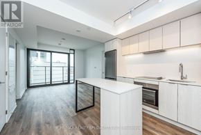 Hamilton (Beasley) condo for rent - A modern kitchen with white cabinets and a wooden floor.