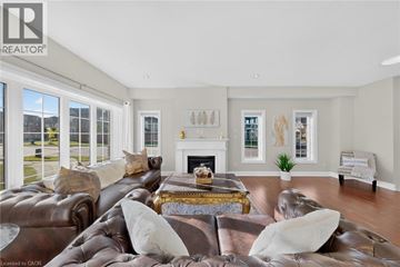 Waterloo apartment for rent - A living room with a brown leather couch and a fireplace.