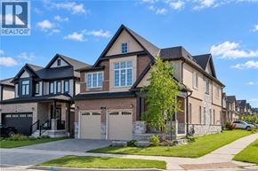Waterloo apartment for rent - A large, two-story house with a garage is situated on a quiet street.