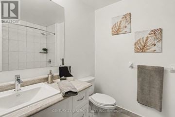 Smiths Falls multi-family for rent - A bathroom with a toilet, sink, and towel.