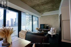 Toronto (Waterfront Communities) condo for rent - A living room with a brown couch and a large window.