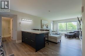 Huntsville (Chaffey) condo for rent - A well-lit kitchen with a dining area and a large window.