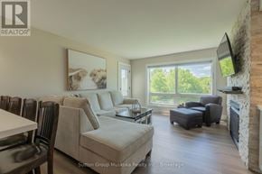 Huntsville (Chaffey) condo for rent - A living room with a fireplace and a television.