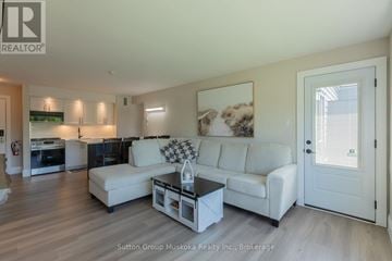 Huntsville (Chaffey) condo for rent - A living room with a white couch and a coffee table.