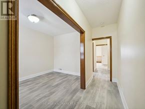 Toronto (Yorkdale-Glen Park) apartment for rent - A hallway with wood floors and white walls.